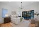 Bright and airy bedroom with hardwood floors, a cozy sitting area, and sliding door to the patio at 639 Edgemont Rd, Charlotte, NC 28211