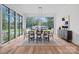 Dining room with large windows, stylish furniture, and natural light at 639 Edgemont Rd, Charlotte, NC 28211