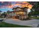Modern home with stone accents, a spacious driveway, and lush landscaping at 639 Edgemont Rd, Charlotte, NC 28211