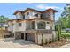 Striking modern home with stone accents, a balcony, and a multi-car garage at 639 Edgemont Rd, Charlotte, NC 28211