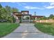 Elegant home with stone and siding exterior, beautifully landscaped front yard, and modern design at 639 Edgemont Rd, Charlotte, NC 28211
