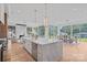 Bright, open kitchen with marble island, stainless steel appliances, and seamless flow to dining and living areas at 639 Edgemont Rd, Charlotte, NC 28211