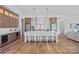 Elegant kitchen featuring a large island with seating, modern lighting, and stylish cabinetry at 639 Edgemont Rd, Charlotte, NC 28211