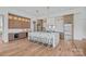 Open concept kitchen featuring a large island, modern appliances, and hardwood floors at 639 Edgemont Rd, Charlotte, NC 28211
