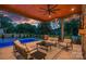 Inviting outdoor patio with a ceiling fan, comfortable seating, and a view of the sparkling pool at twilight at 639 Edgemont Rd, Charlotte, NC 28211