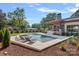 Tranquil backyard oasis with a pool, hot tub, lounge chairs, and manicured landscaping at 639 Edgemont Rd, Charlotte, NC 28211