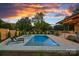 Beautiful backyard with an in-ground pool, spa, outdoor kitchen and seating at sunset at 639 Edgemont Rd, Charlotte, NC 28211