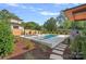 Beautiful pool with stone pavers, well-manicured landscaping, privacy fence and adjacent lounge area at 639 Edgemont Rd, Charlotte, NC 28211