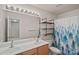 Traditional bathroom features a large mirror, double vanity, and a shower with a decorative curtain at 6834 Creft Cir, Indian Trail, NC 28079