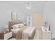 Comfortable bedroom with neutral tones, accent wall, ceiling fan, and ample natural light at 6834 Creft Cir, Indian Trail, NC 28079