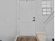 Simple white front door and stairs, with vinyl floors and painted gray walls at 6834 Creft Cir, Indian Trail, NC 28079