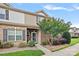 Charming townhome entrance featuring a brick facade, landscaped garden, and well-lit pathway at 6834 Creft Cir, Indian Trail, NC 28079
