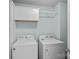 Clean laundry room with washer, dryer, storage cabinets and light blue walls at 6834 Creft Cir, Indian Trail, NC 28079