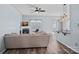 Bright living room with hardwood floors, fireplace, ceiling fan, and an open bar to the kitchen at 6834 Creft Cir, Indian Trail, NC 28079