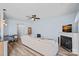 Bright living room with a fireplace, ceiling fan, hardwood floors, and comfortable furnishings at 6834 Creft Cir, Indian Trail, NC 28079