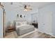 Stylish main bedroom with a decorative ceiling fan, light blue walls, and ample natural light at 6834 Creft Cir, Indian Trail, NC 28079