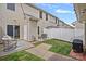 Back patio with an open door leading to a fenced backyard, outdoor seating and grill at 6834 Creft Cir, Indian Trail, NC 28079