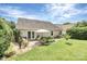 Well-maintained backyard with patio, seating, and mature landscaping at 7526 Shadowstone Dr, Charlotte, NC 28270