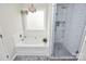 Bright bathroom featuring a soaking tub with large window and a glass-enclosed tiled shower at 7526 Shadowstone Dr, Charlotte, NC 28270
