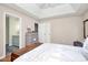 Calm bedroom features a ceiling fan, bedside tables, and doorway to ensuite bathroom at 7526 Shadowstone Dr, Charlotte, NC 28270