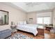 Relaxing bedroom with tray ceiling featuring a comfortable bed, bedside tables, and natural light at 7526 Shadowstone Dr, Charlotte, NC 28270