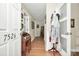 Welcoming hallway featuring hardwood floors, elegant trim, and a glimpse into other rooms at 7526 Shadowstone Dr, Charlotte, NC 28270