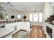 Bright kitchen with white cabinets, hardwood floors, and a cozy breakfast nook at 7526 Shadowstone Dr, Charlotte, NC 28270