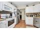 Well-equipped kitchen with white appliances, ample cabinet space, and wood flooring at 7526 Shadowstone Dr, Charlotte, NC 28270