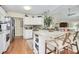 Open kitchen featuring a center island, white cabinets, and stainless steel appliances at 7526 Shadowstone Dr, Charlotte, NC 28270