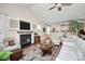 Inviting living room featuring a fireplace with mounted television, hardwood floors, and comfortable seating at 7526 Shadowstone Dr, Charlotte, NC 28270