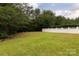 Spacious backyard featuring green grass and a well-maintained white fence at 7623 Monarch Birch Ln, Charlotte, NC 28215