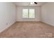Bright bedroom featuring neutral carpet and a ceiling fan at 7623 Monarch Birch Ln, Charlotte, NC 28215