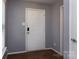 A white front door with a digital lock offers secure access at 7623 Monarch Birch Ln, Charlotte, NC 28215