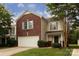 Charming two-story home with brick and siding, attached garage and well-manicured lawn at 7623 Monarch Birch Ln, Charlotte, NC 28215