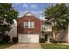 Charming two-story home features a brick facade and an attached two-car garage at 7623 Monarch Birch Ln, Charlotte, NC 28215