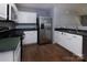 Functional kitchen featuring stainless steel appliances, white cabinetry, and modern fixtures at 7623 Monarch Birch Ln, Charlotte, NC 28215