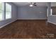 A spacious living room features wood-look tile flooring and natural light at 7623 Monarch Birch Ln, Charlotte, NC 28215