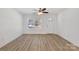 Bright, spacious living room featuring hardwood floors, neutral walls, a ceiling fan, and lots of natural light from large windows at 81 Kirk St, Salisbury, NC 28144