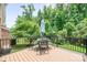 Spacious back deck with table and chairs overlooking a lush backyard at 8232 Bretton Woods Dr, Charlotte, NC 28227