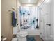 Bathroom featuring a shower-tub, toilet, decorative shower curtain, and tile flooring at 8232 Bretton Woods Dr, Charlotte, NC 28227