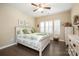 Cozy bedroom features a ceiling fan, shutters, neutral walls, and wood-look flooring at 8232 Bretton Woods Dr, Charlotte, NC 28227