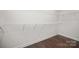 Walk-in closet features wood-look floors and white shelving at 8232 Bretton Woods Dr, Charlotte, NC 28227
