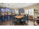 Dining area featuring a table with seating for six, wooden floors and views of the gourmet kitchen at 8232 Bretton Woods Dr, Charlotte, NC 28227