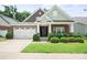 Charming single-Gathering home featuring a two-car garage, brick facade, landscaped yard and covered front porch at 8232 Bretton Woods Dr, Charlotte, NC 28227