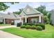 Charming front exterior featuring a brick facade, well-manicured bushes, and a welcoming entrance at 8232 Bretton Woods Dr, Charlotte, NC 28227