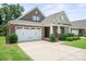 Beautiful home with a brick facade, large garage, and well-kept lawn and garden at 8232 Bretton Woods Dr, Charlotte, NC 28227