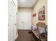 Entryway features a bench with pillows, wood-look flooring, and neutral walls at 8232 Bretton Woods Dr, Charlotte, NC 28227