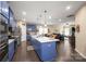 Bright, airy kitchen with blue cabinets, a large island, pendant lights, and open layout to the living area at 8232 Bretton Woods Dr, Charlotte, NC 28227