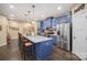 Spacious kitchen with a large center island, stainless steel appliances, and blue cabinetry at 8232 Bretton Woods Dr, Charlotte, NC 28227