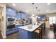 Modern kitchen with stainless steel appliances, blue cabinets, white countertops and a large center island at 8232 Bretton Woods Dr, Charlotte, NC 28227